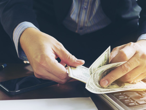 Business man counting dollar banknote - online business concept