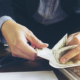 Business man counting dollar banknote - online business concept