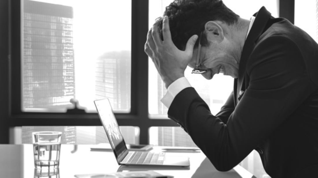 Stressed young businessman overworking