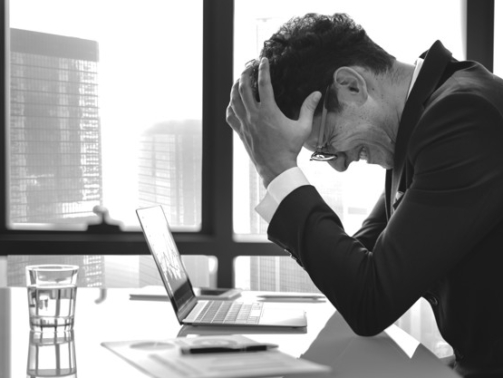 Stressed young businessman overworking