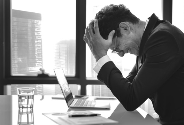 Stressed young businessman overworking